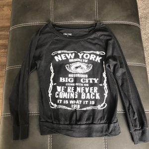 Women’s black long sleeve shirt.